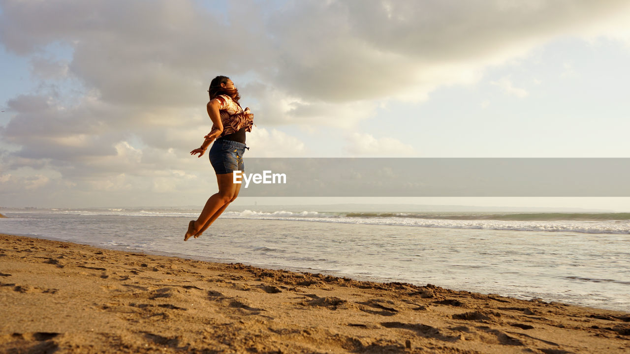 Full length of young woman on beach