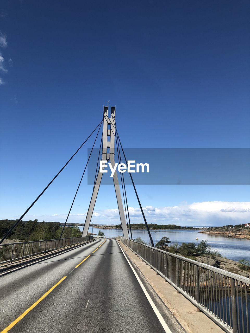 View of suspension bridge against blue sky