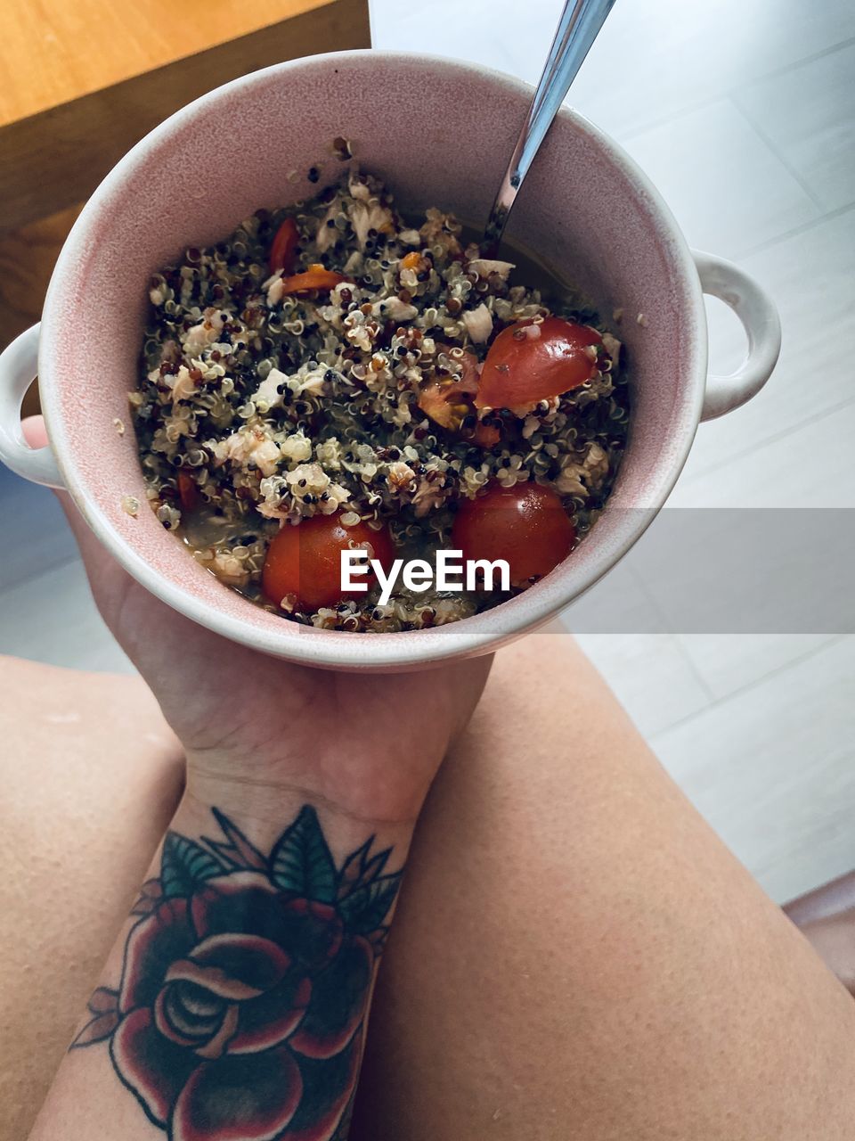 HIGH ANGLE VIEW OF MAN HOLDING BOWL OF FOOD