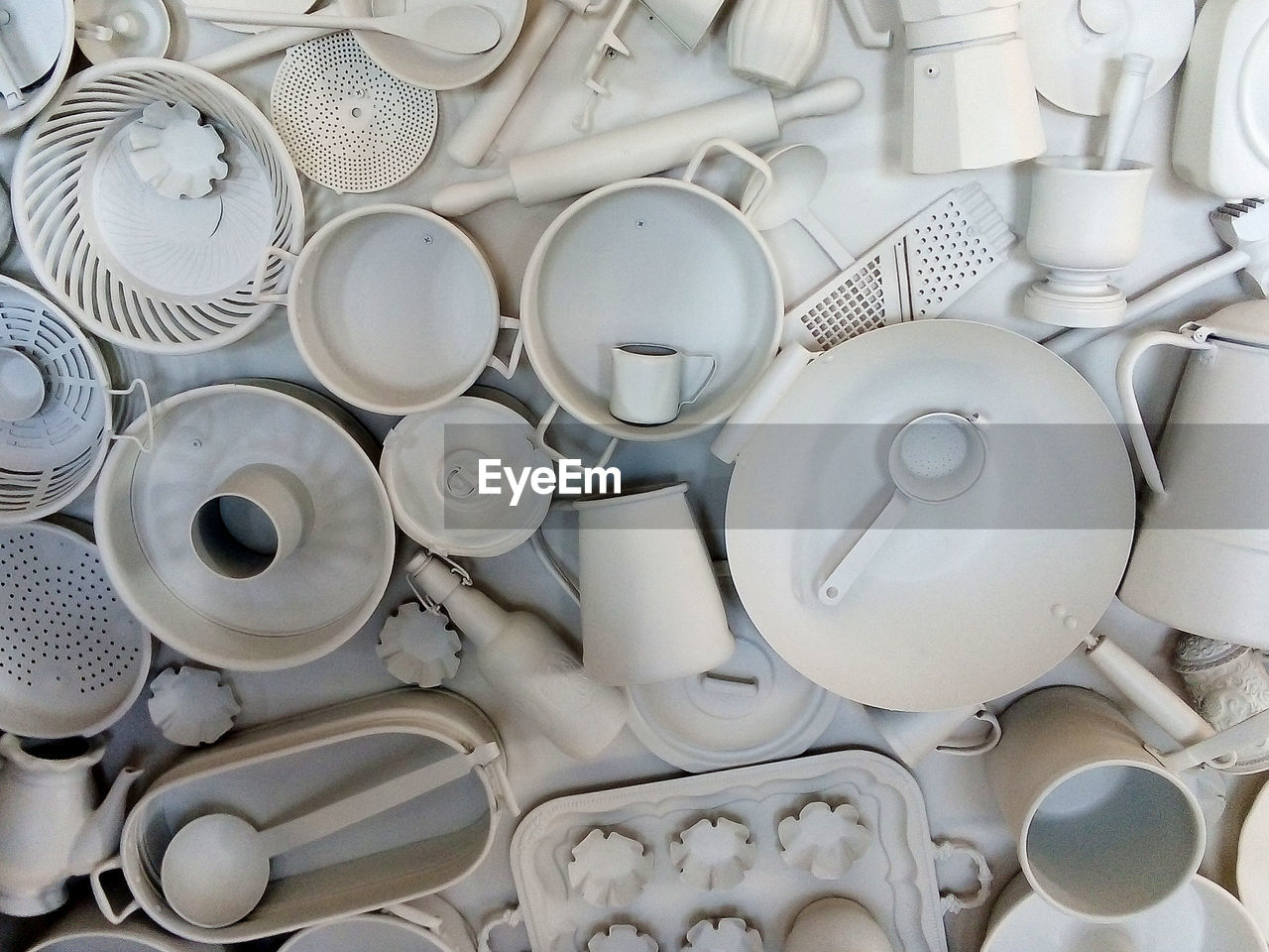 White painted kitchen utensils decorating the wall