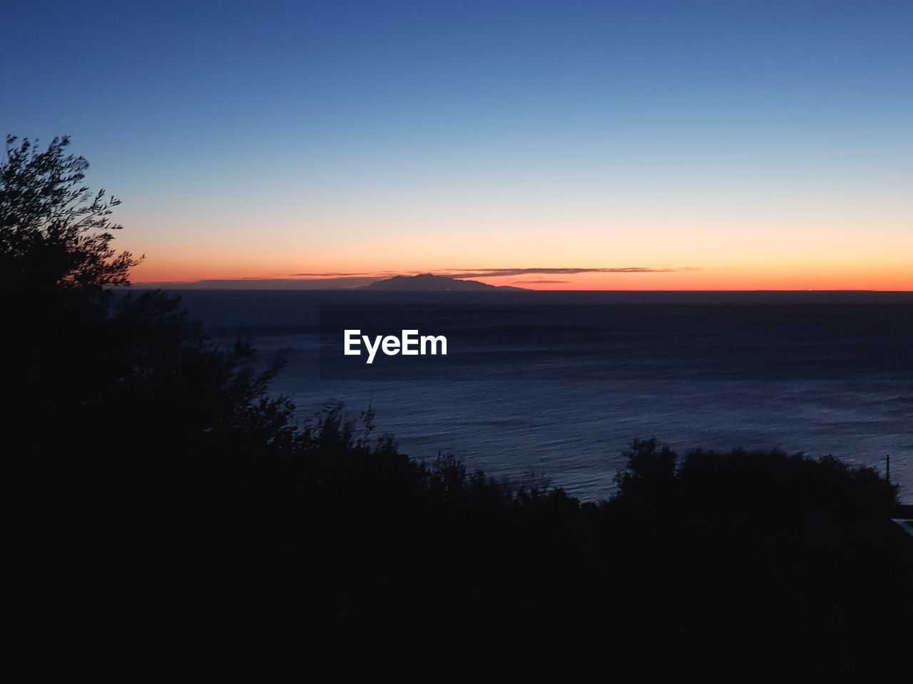 SCENIC VIEW OF SEA AGAINST ORANGE SKY