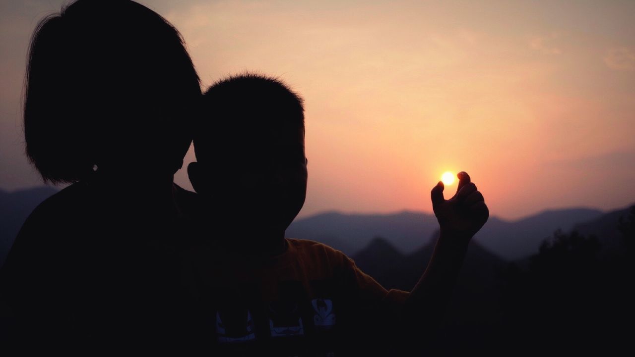 SILHOUETTE OF WOMAN AT SUNSET