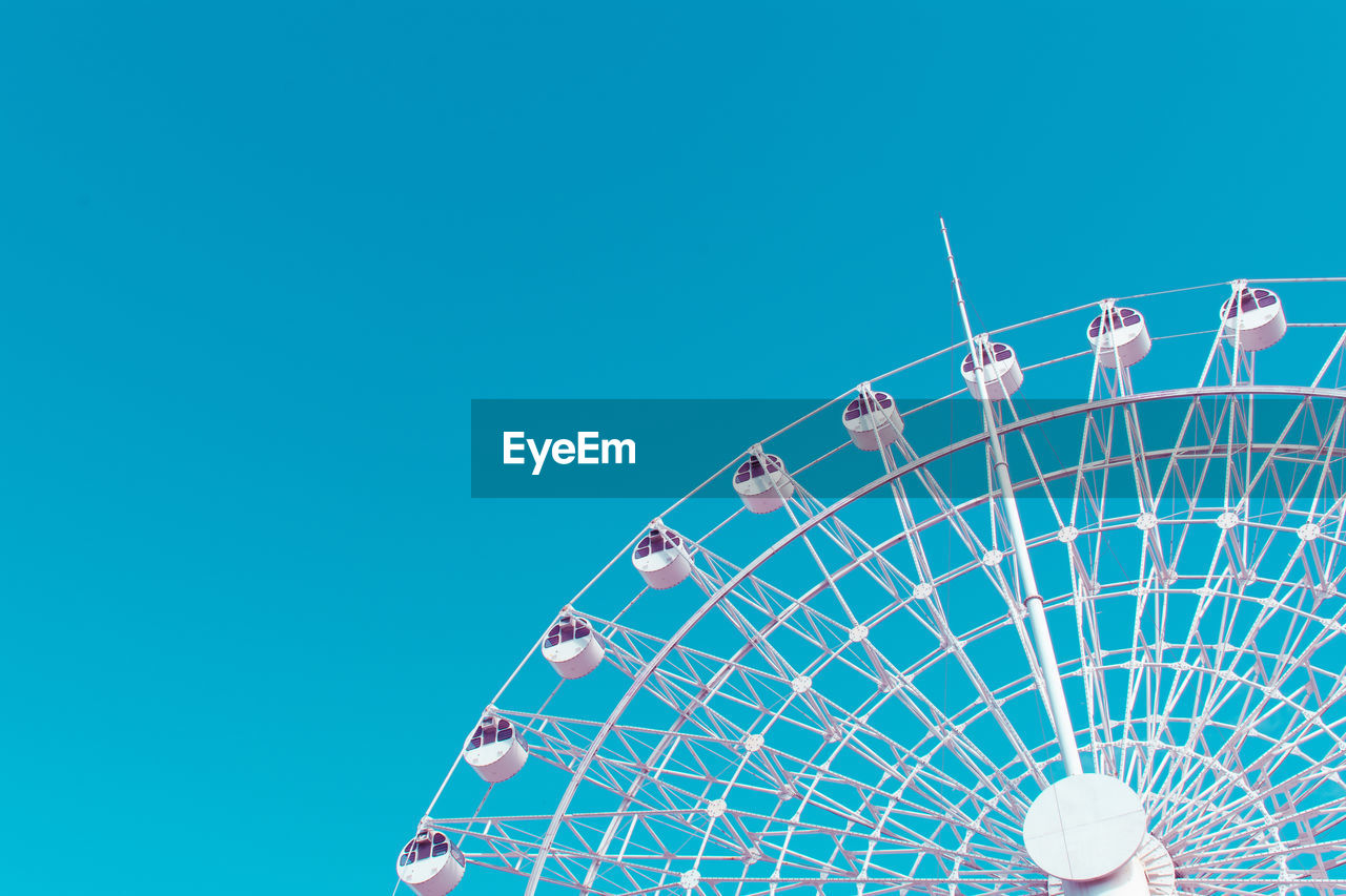 Ferris wheel with blue sky background