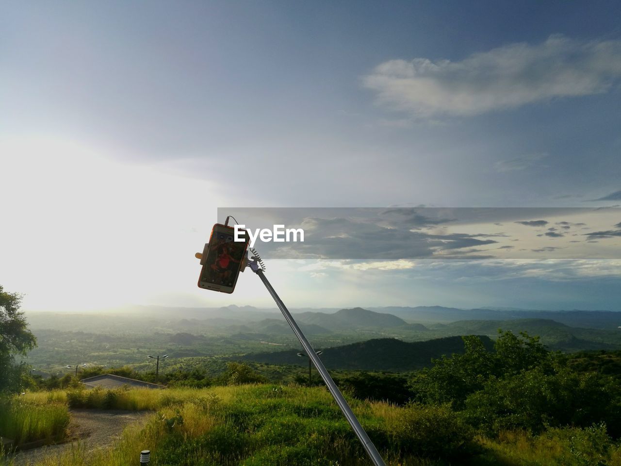 LOW ANGLE VIEW OF WIND TURBINES ON LANDSCAPE AGAINST SKY