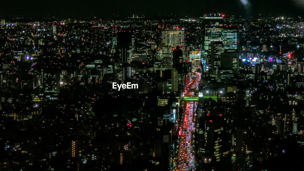 Aerial view of illuminated city buildings at night