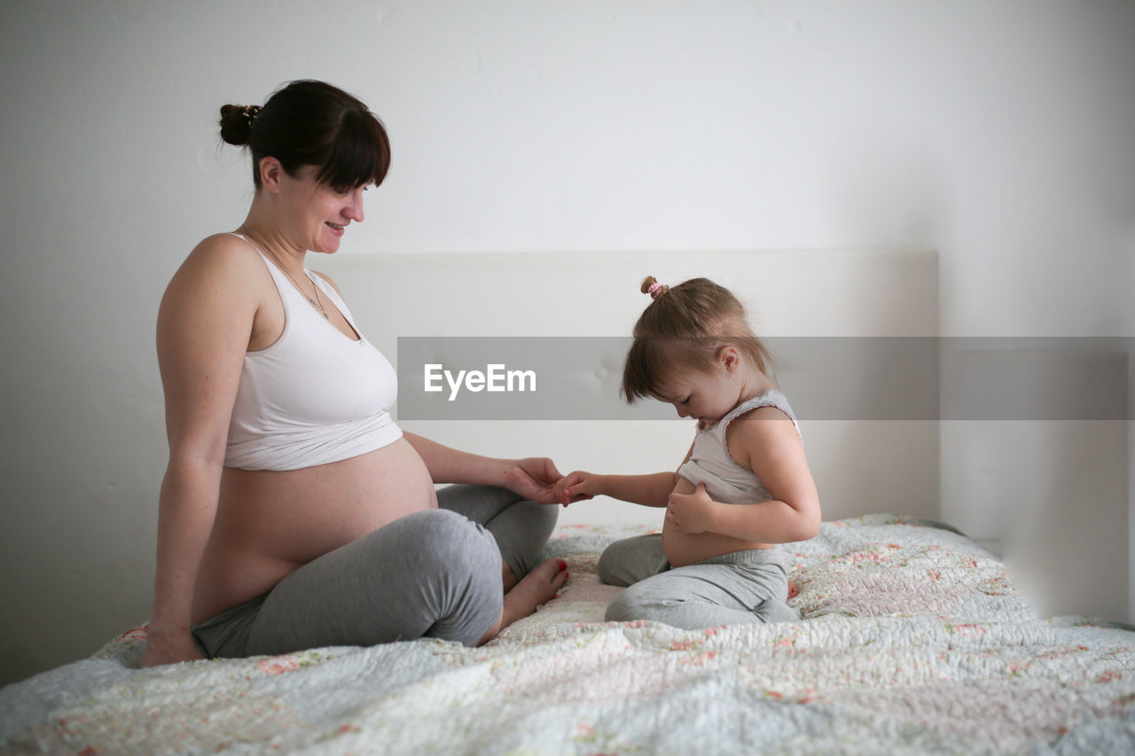 Pregnant mother with daughters, life style in a real interior. the concept of large families 