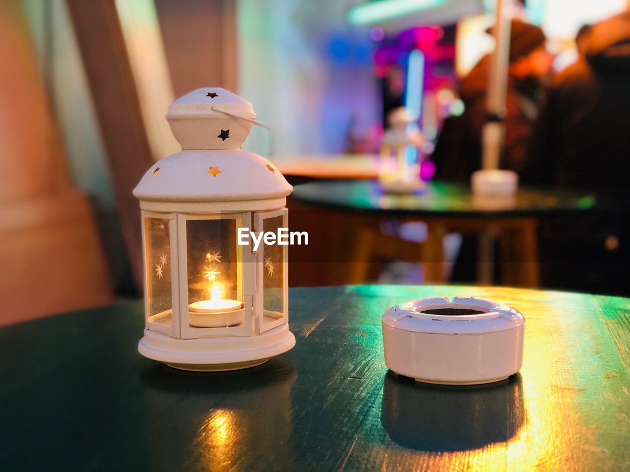 Close-up of illuminated lantern on table in restaurant