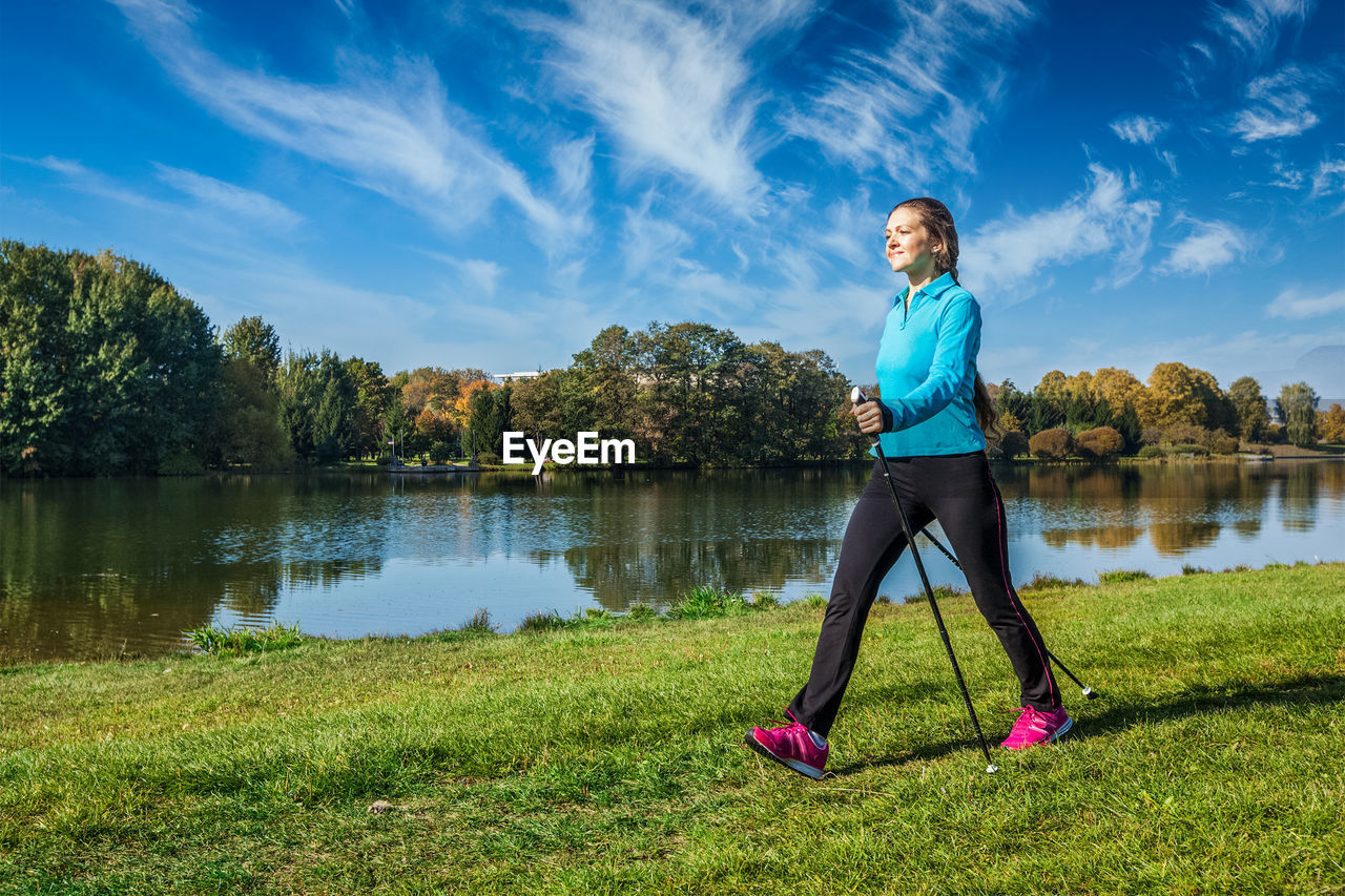Young woman nordic walking