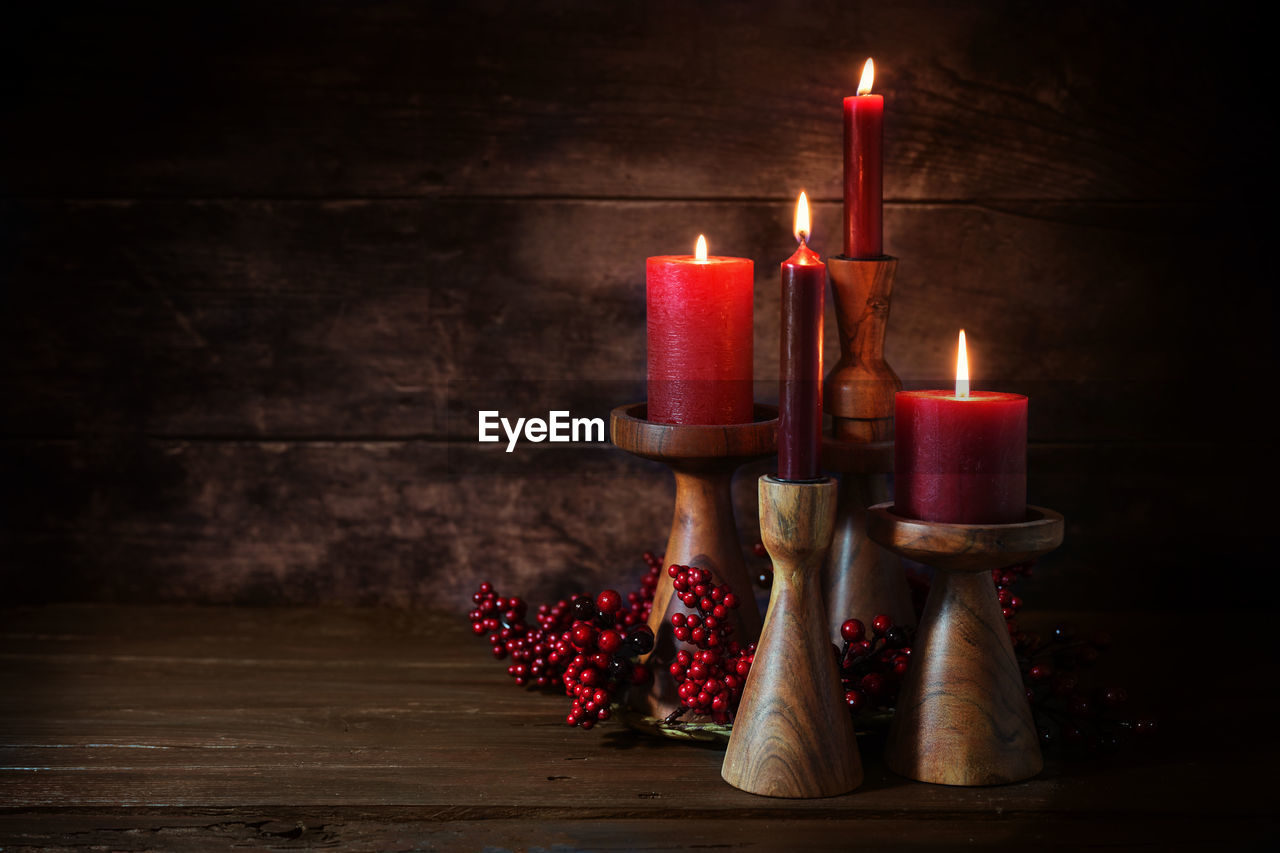 high angle view of illuminated candles on table