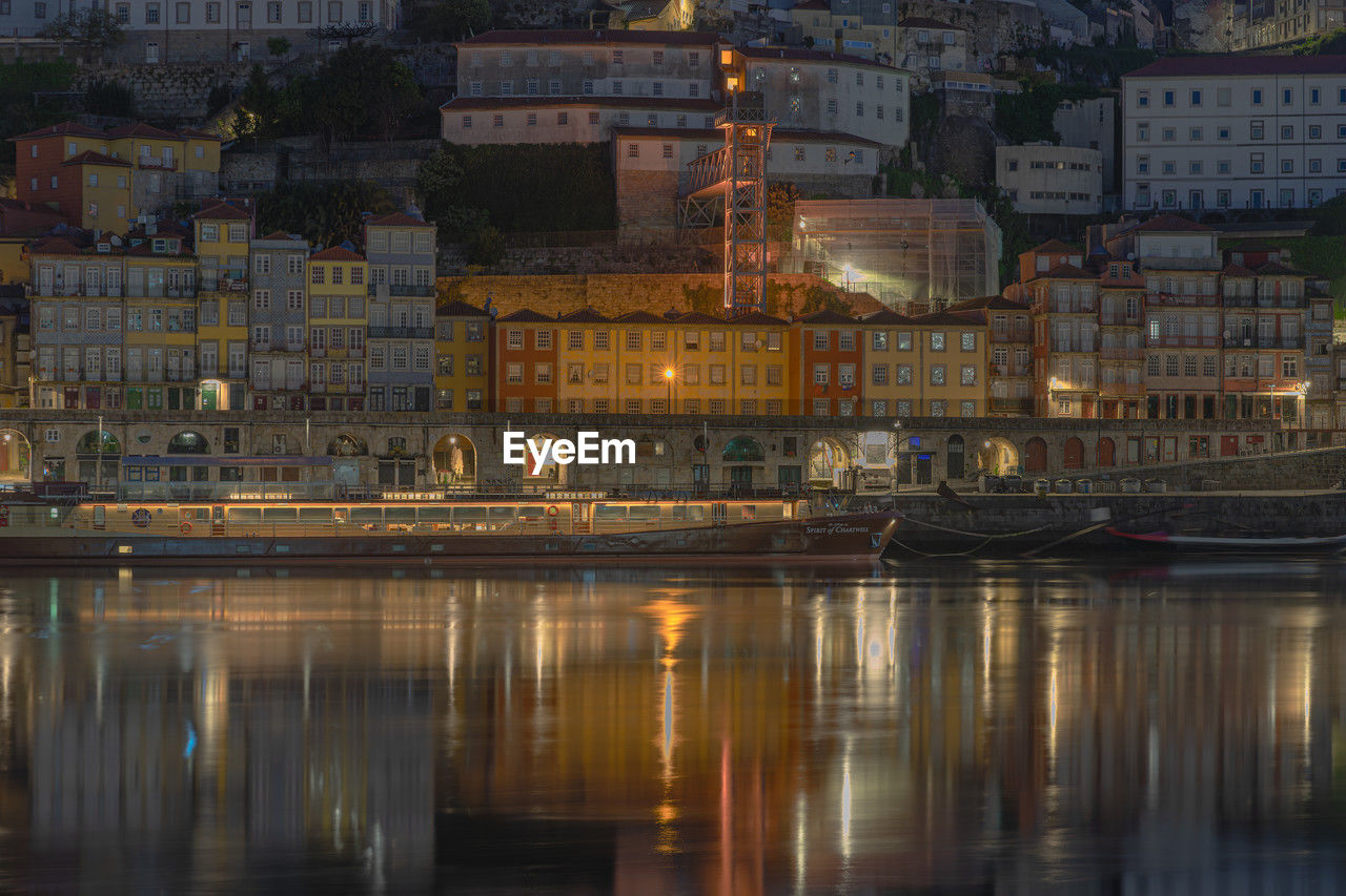 reflection of illuminated buildings in water at night