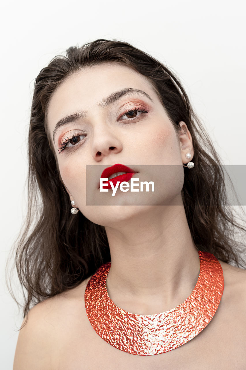 Portrait of beautiful young woman over white background