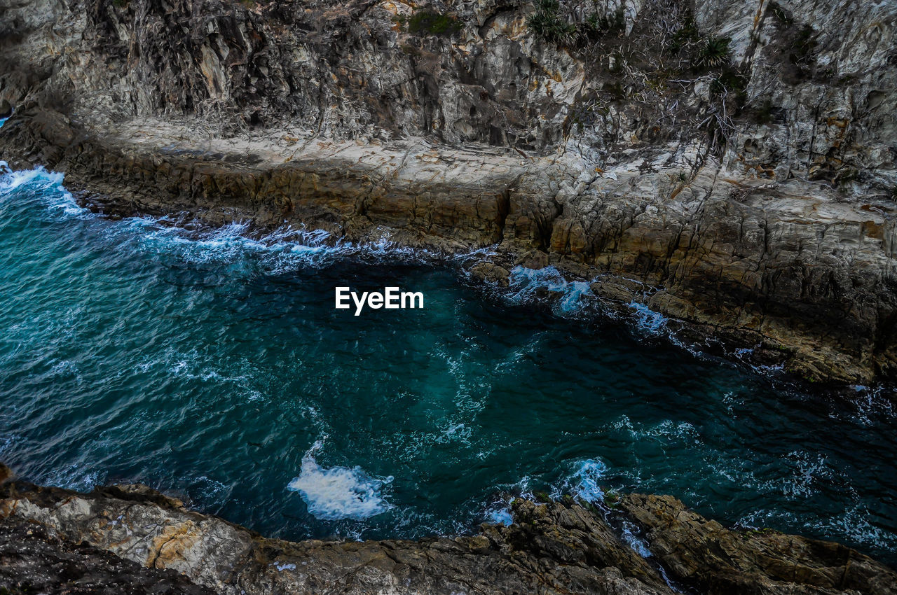 High angle view of rocks in sea