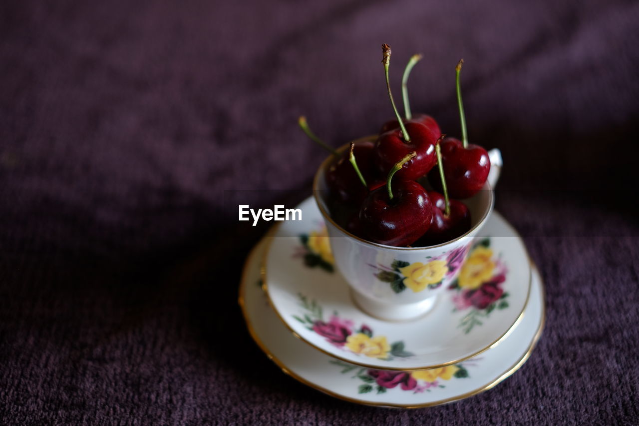 Close-up of cherries served on table