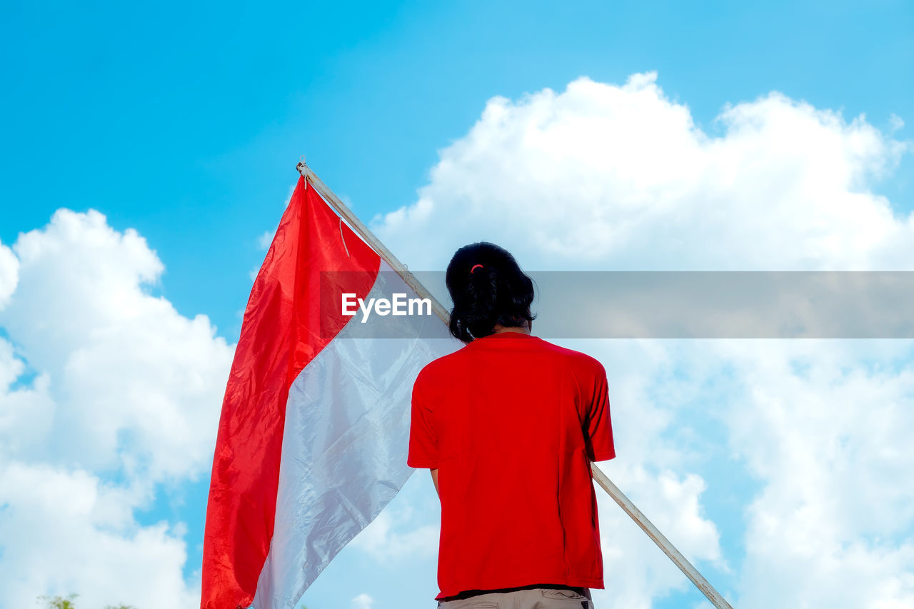 A person holding the indonesian national flag. indonesian independence day