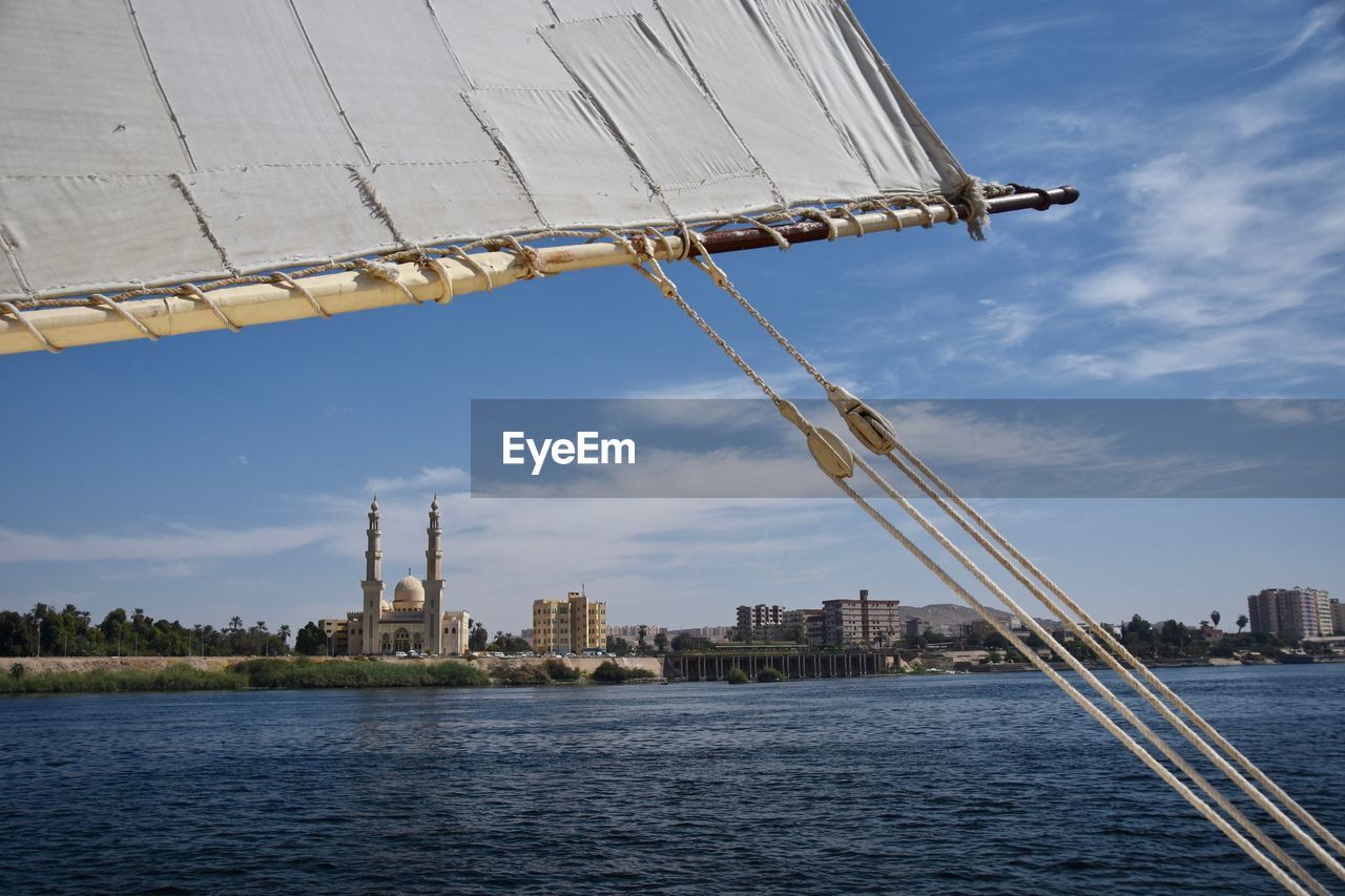 Mosque by river nile against sky