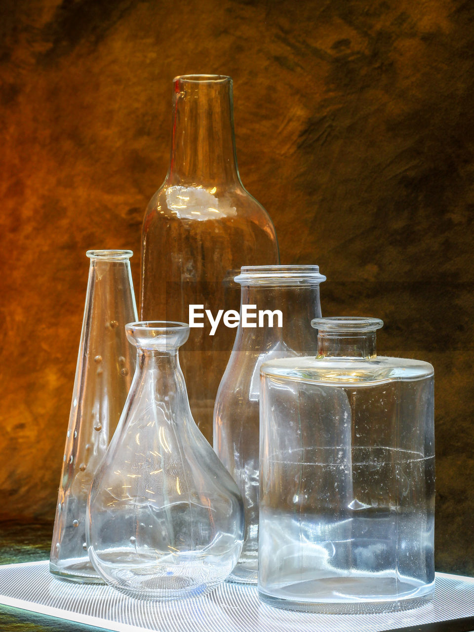 Empty glass containers on table