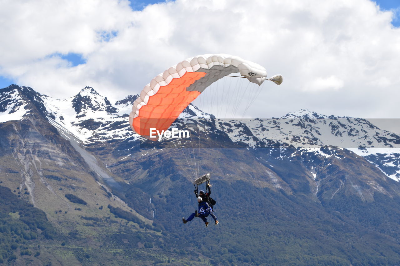 PERSON PARAGLIDING AGAINST SKY