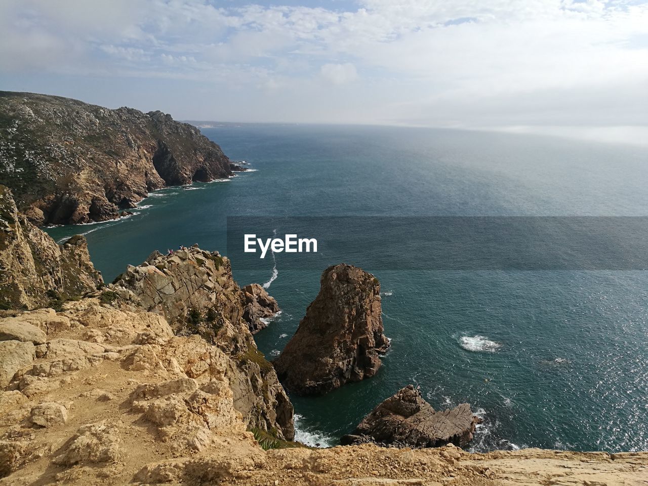 SCENIC VIEW OF ROCKS ON SEA AGAINST SKY