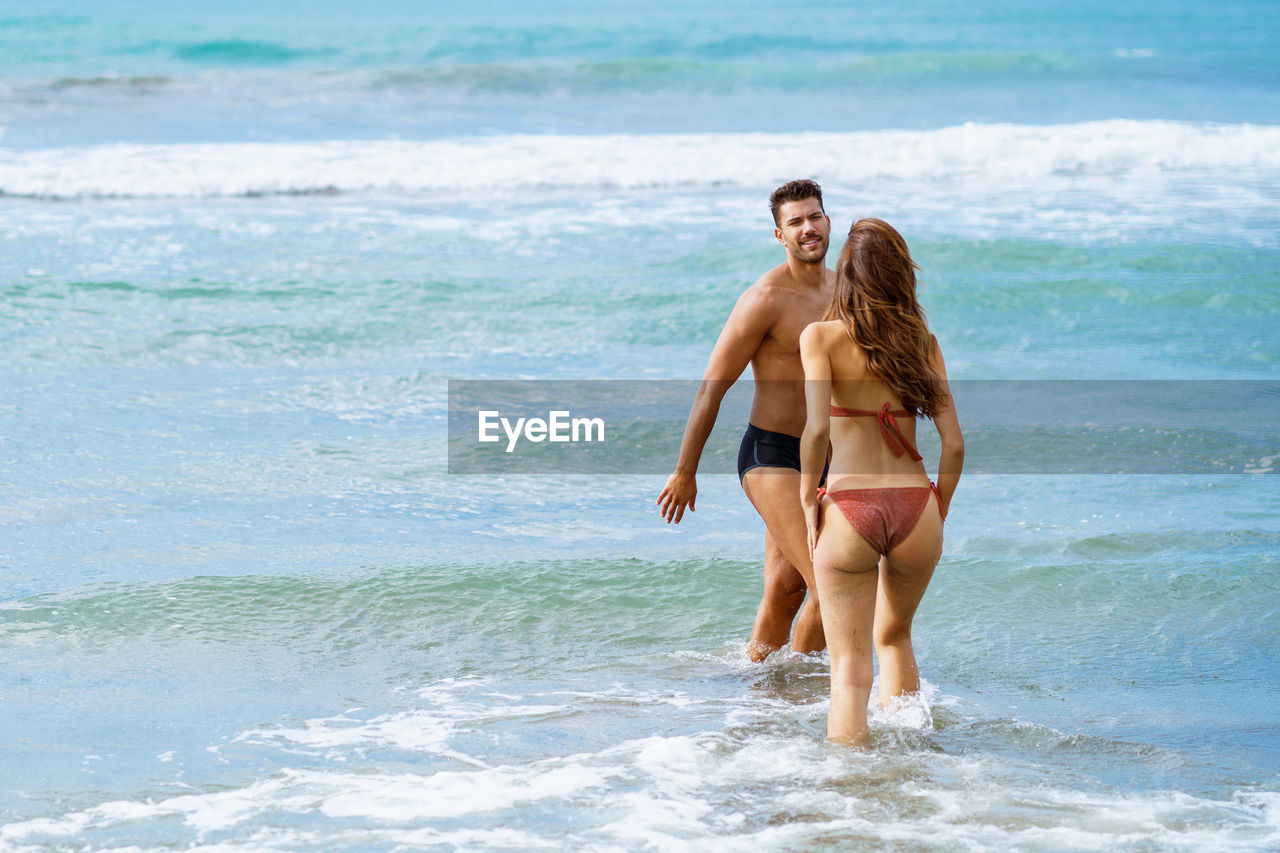 Young couple standing in seashore