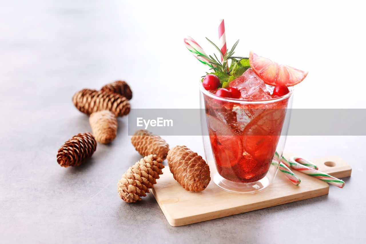 CLOSE-UP OF FRUITS IN GLASS WITH TABLE