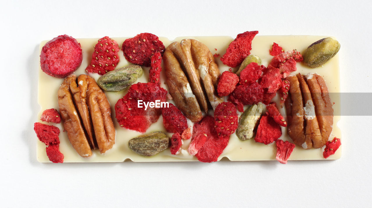 High angle view of handmade chocolates on white background