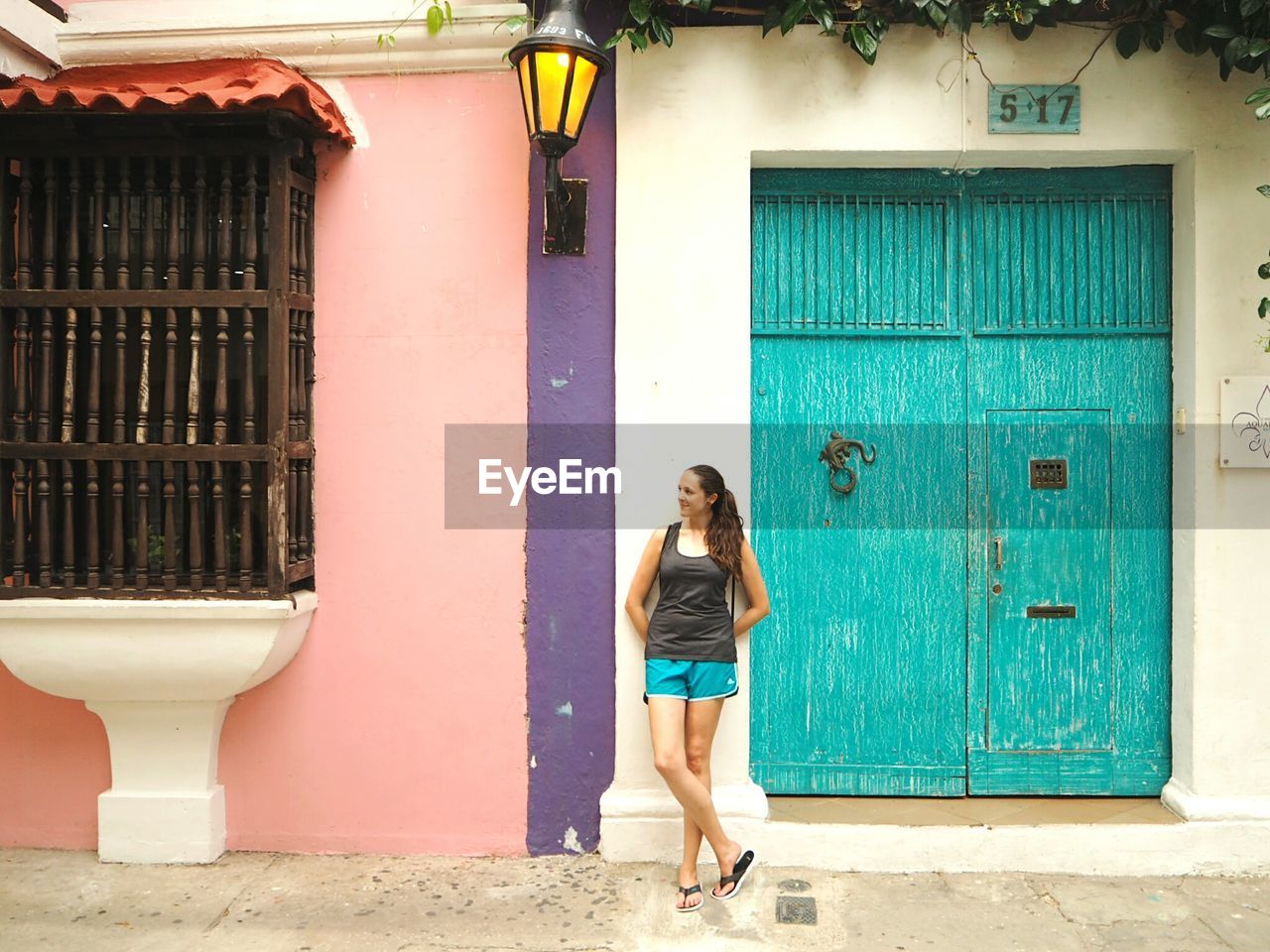 Full length of woman standing against building