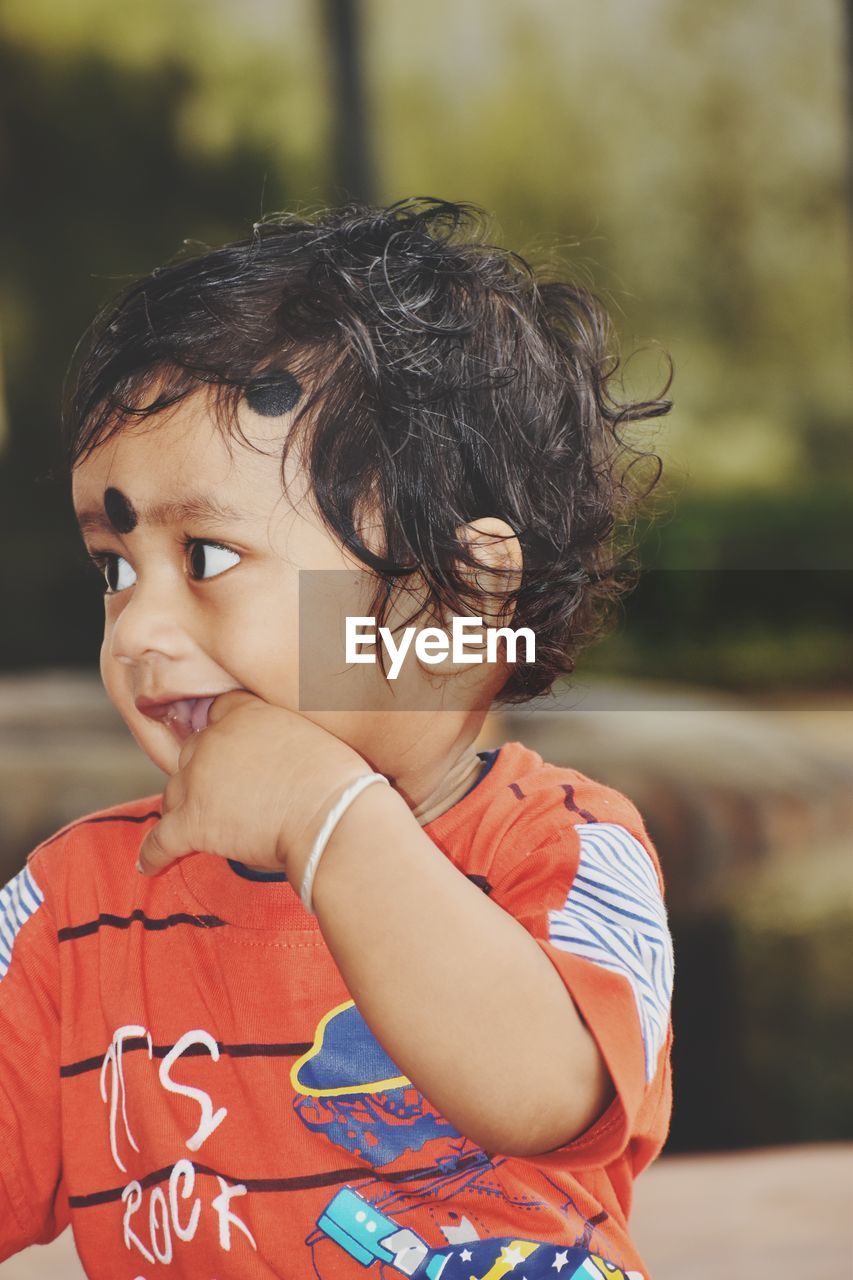 CLOSE-UP PORTRAIT OF CUTE BOY LOOKING AWAY