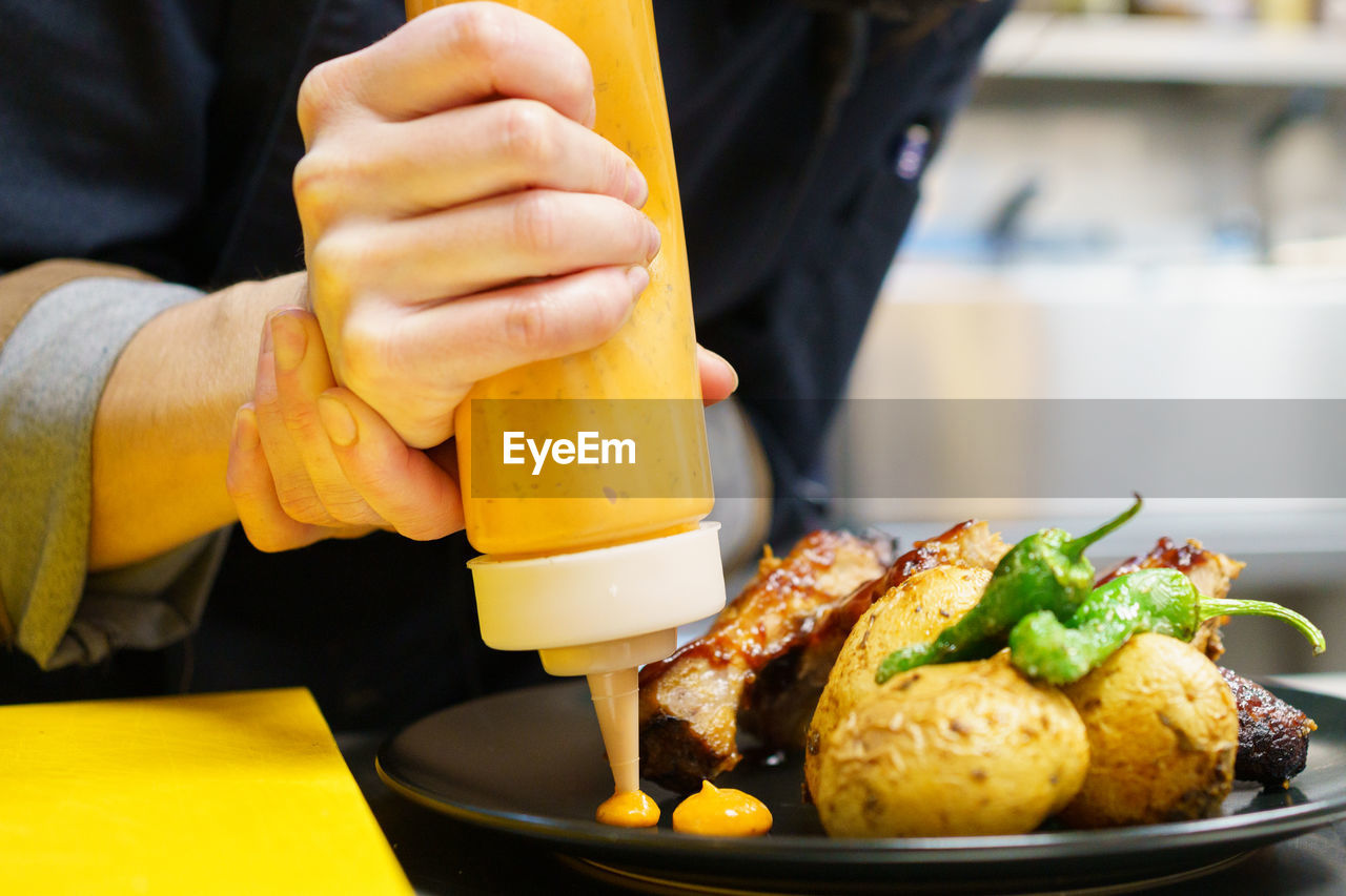 midsection of man preparing food on table