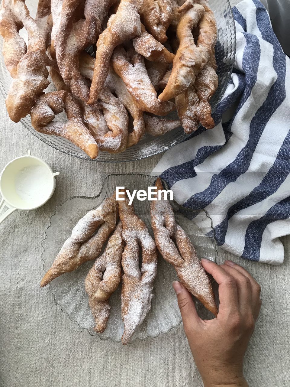 High angle view of hand holding pastry on table