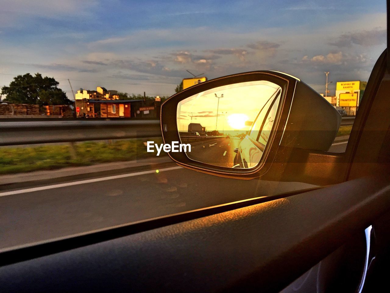 Reflection of street on side-view mirror