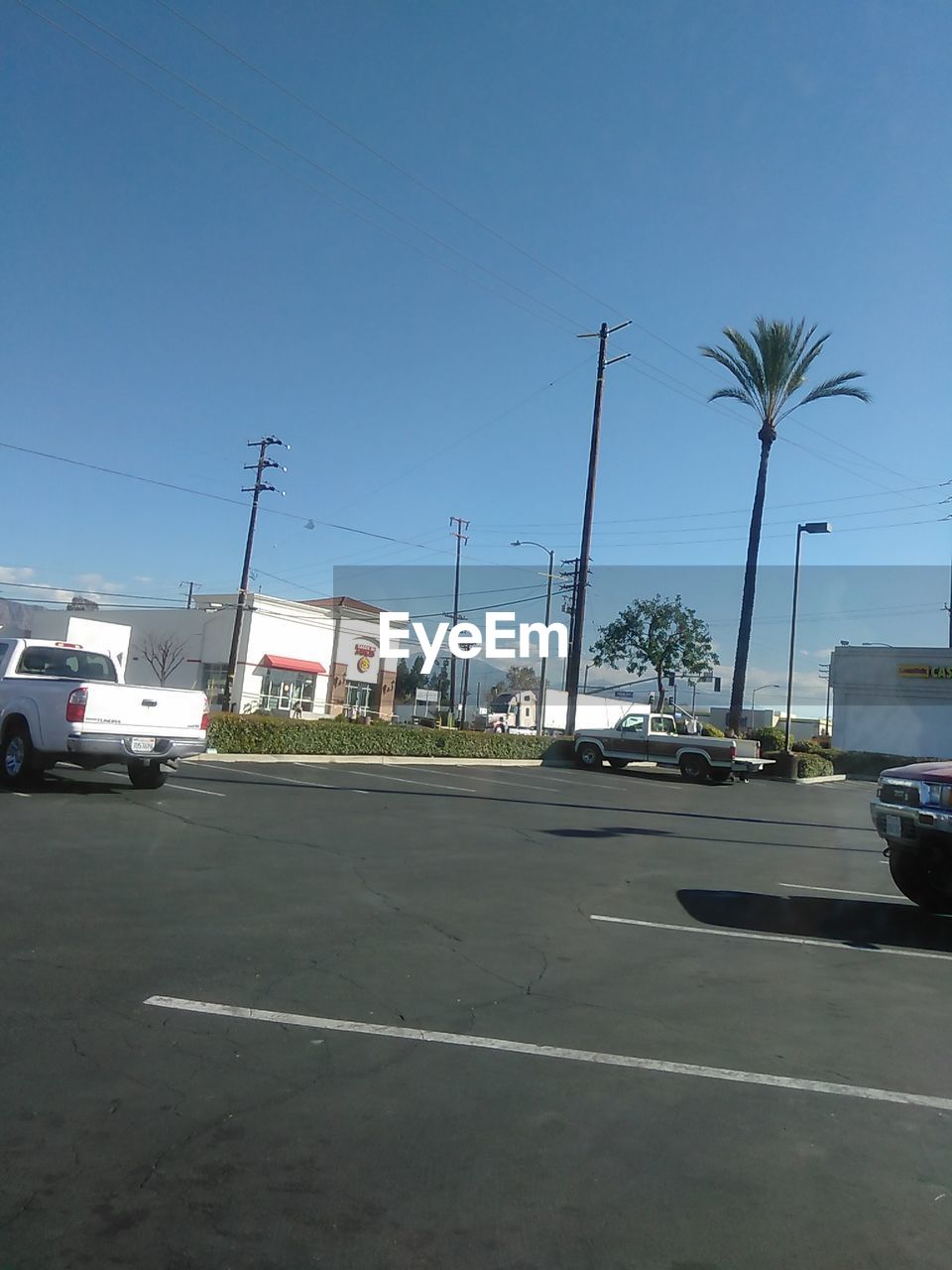 CARS ON ROAD AGAINST CLEAR SKY