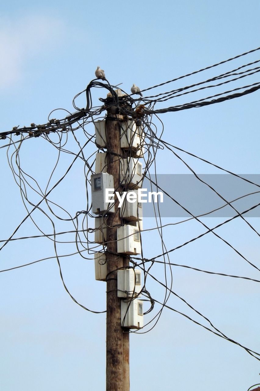 LOW ANGLE VIEW OF ELECTRICITY PYLONS AGAINST CLEAR SKY