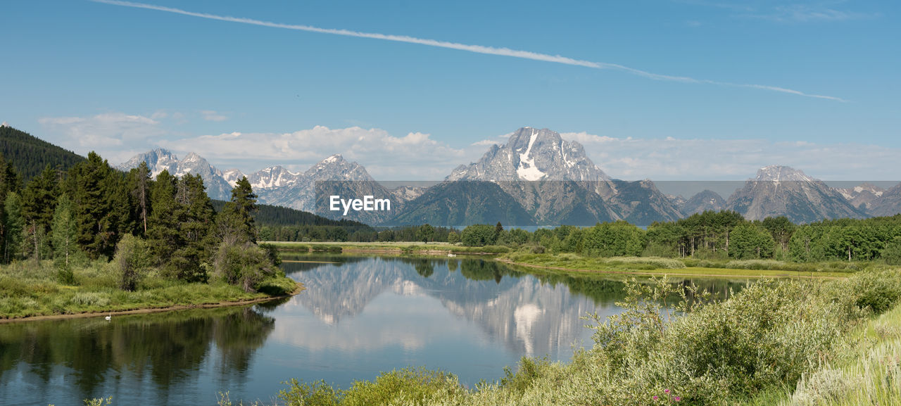 Scenic view of lake and mountains against sky in the grand tetons