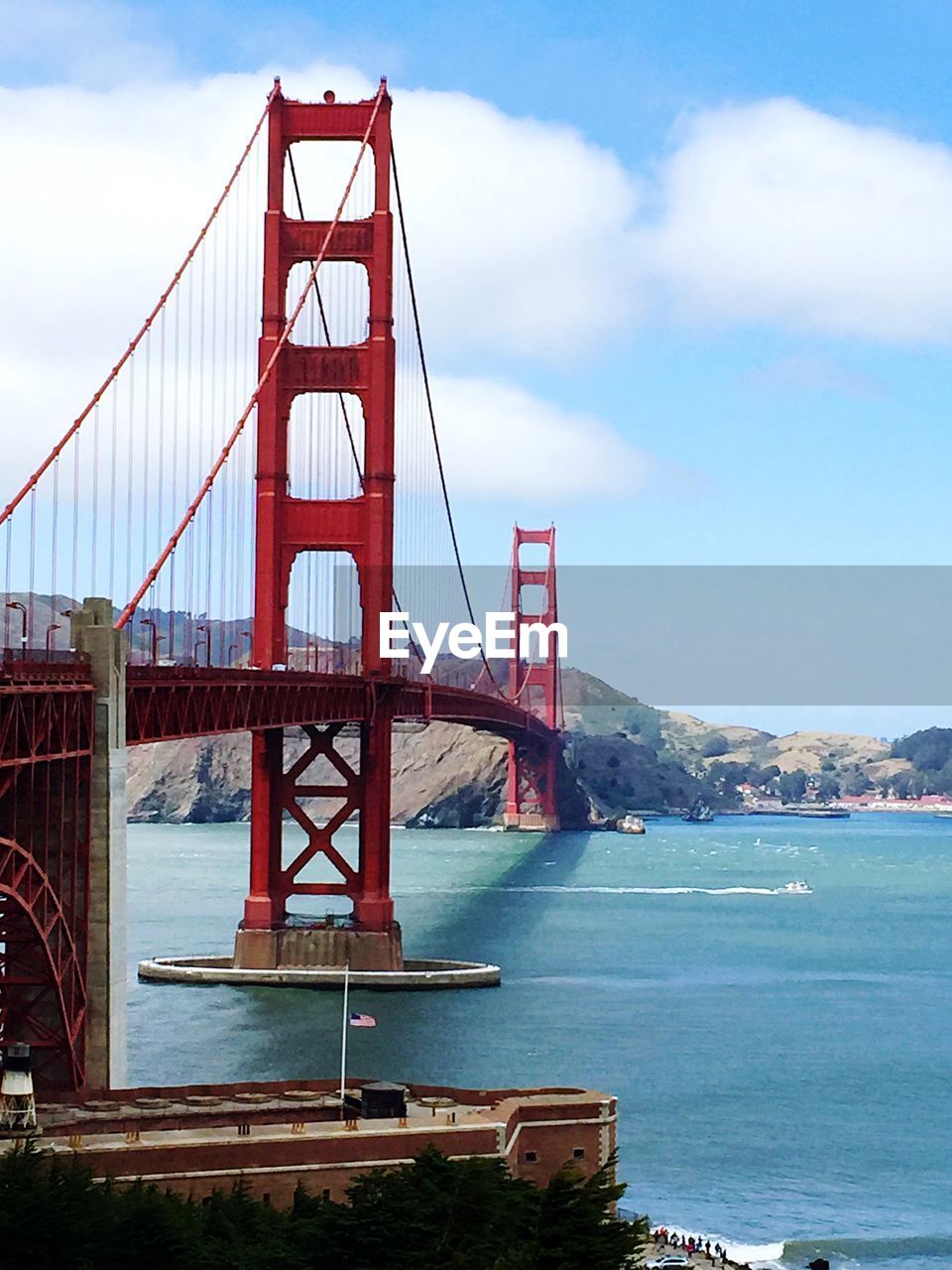 Golden gate bridge over sea against sky in city