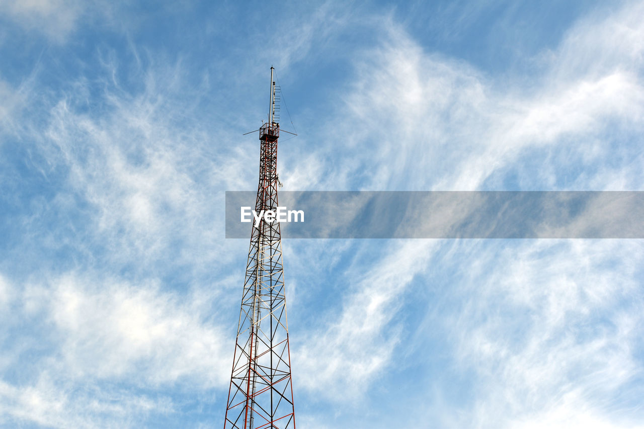 Low angle view of communications tower against sky