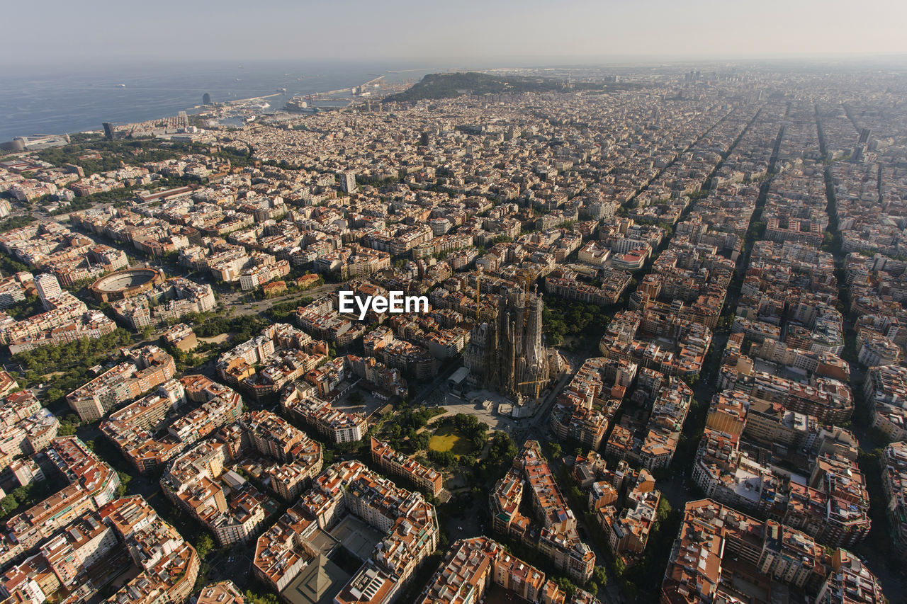 Spain, catalonia, barcelona, helicopter view of sagrada familia basilica and surrounding cityscape
