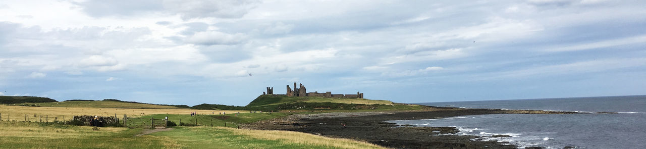 Panoramic view of castle against cloudy sky
