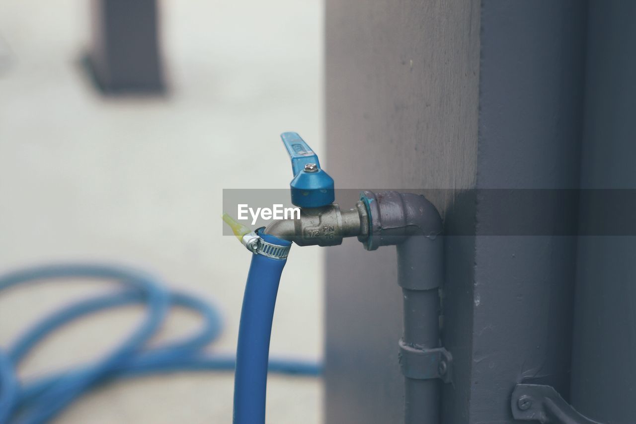 Close-up of faucet against wall