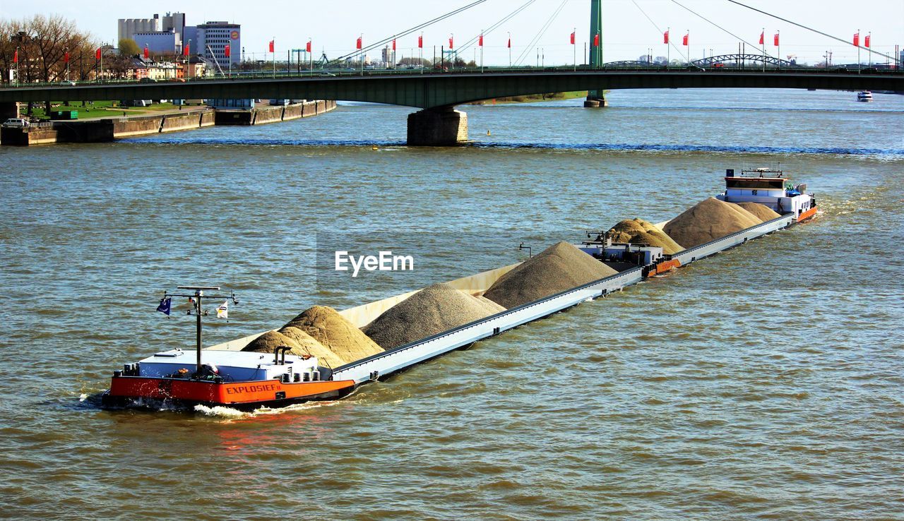 High angle view of boat carrying soil on river
