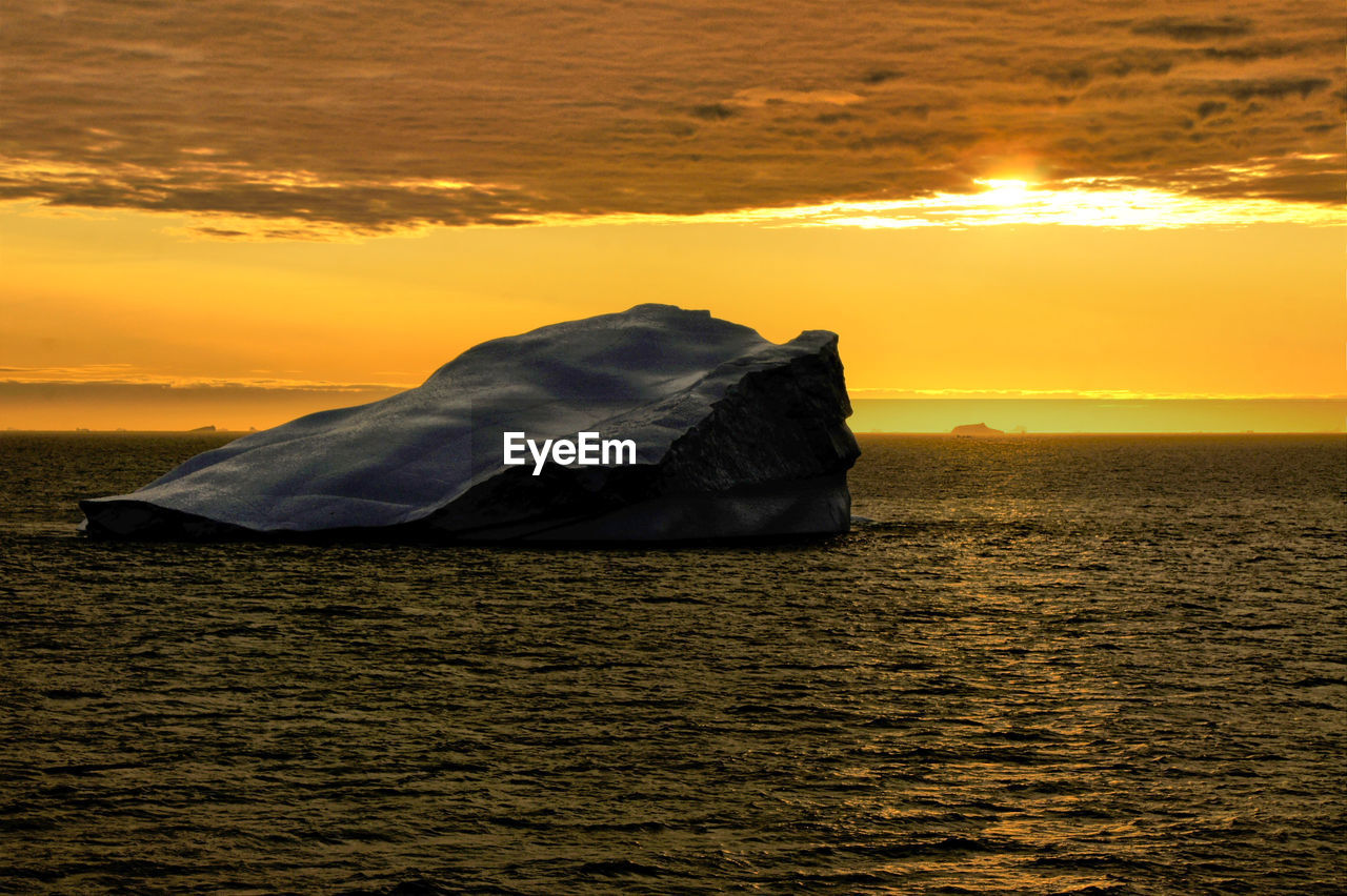 Iceberg off greenland in the davis strait at sunset