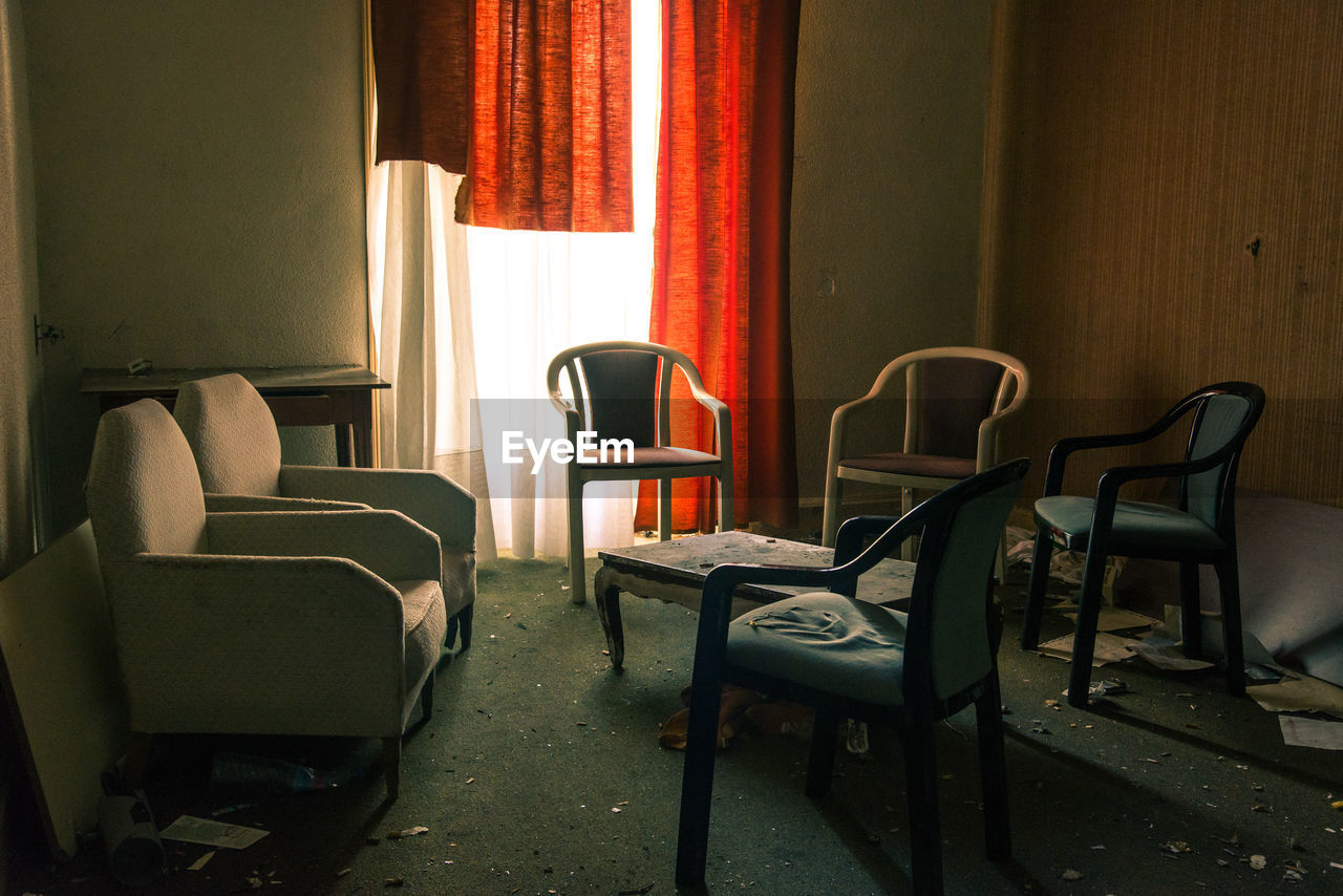 empty chairs and tables and table in living room