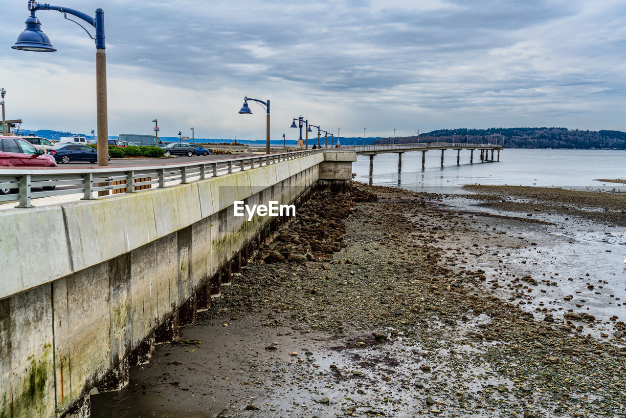 water, walkway, sky, sea, coast, architecture, beach, built structure, cloud, transportation, nature, pier, shore, land, bridge, waterway, city, no people, travel, environment, travel destinations, ocean, boardwalk, body of water, street, day, outdoors, coastline, scenics - nature, building exterior, road, sand, tourism, channel, beauty in nature, mode of transportation, landscape, tranquility