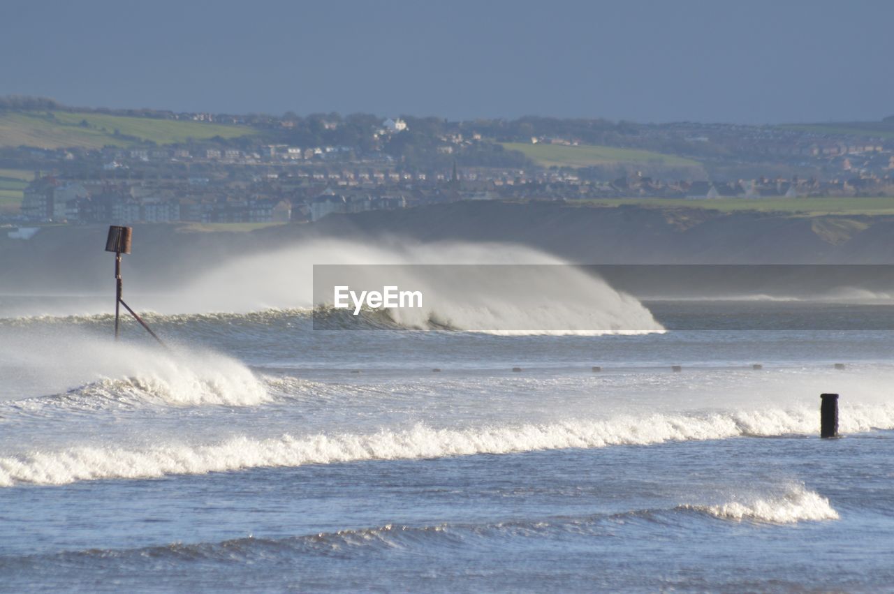 WAVES BREAKING AGAINST SEA