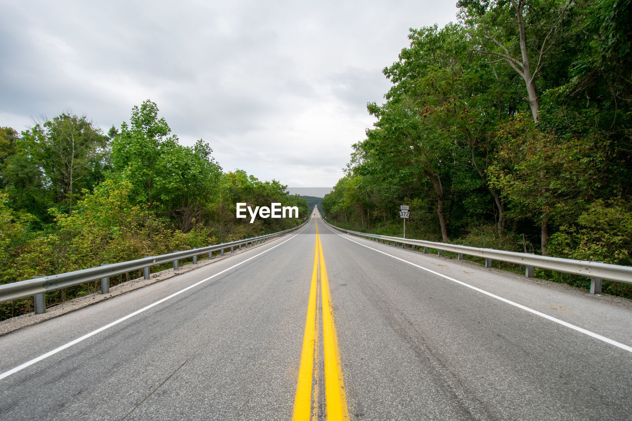 A shot from the center of a road with the norman wood bridge up ahead