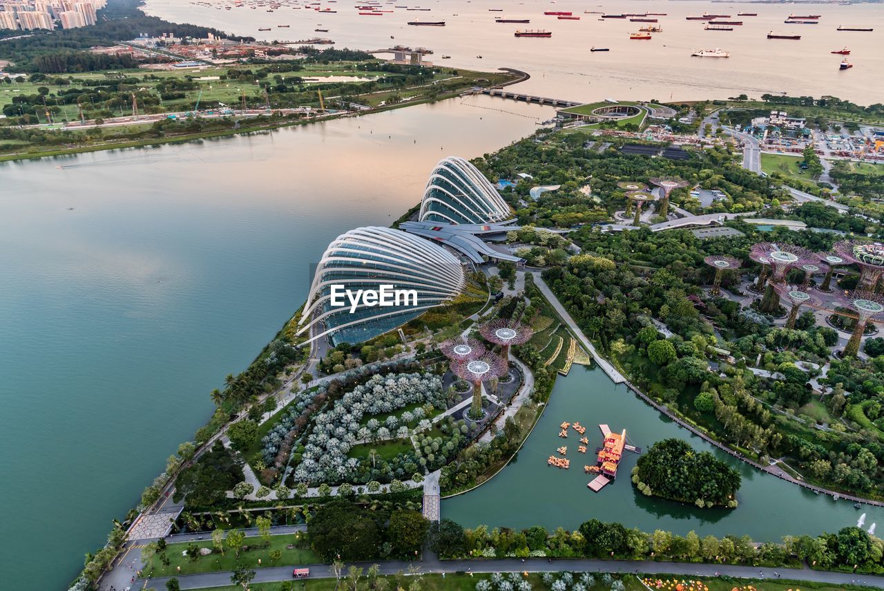 High angle view of river amidst trees in city