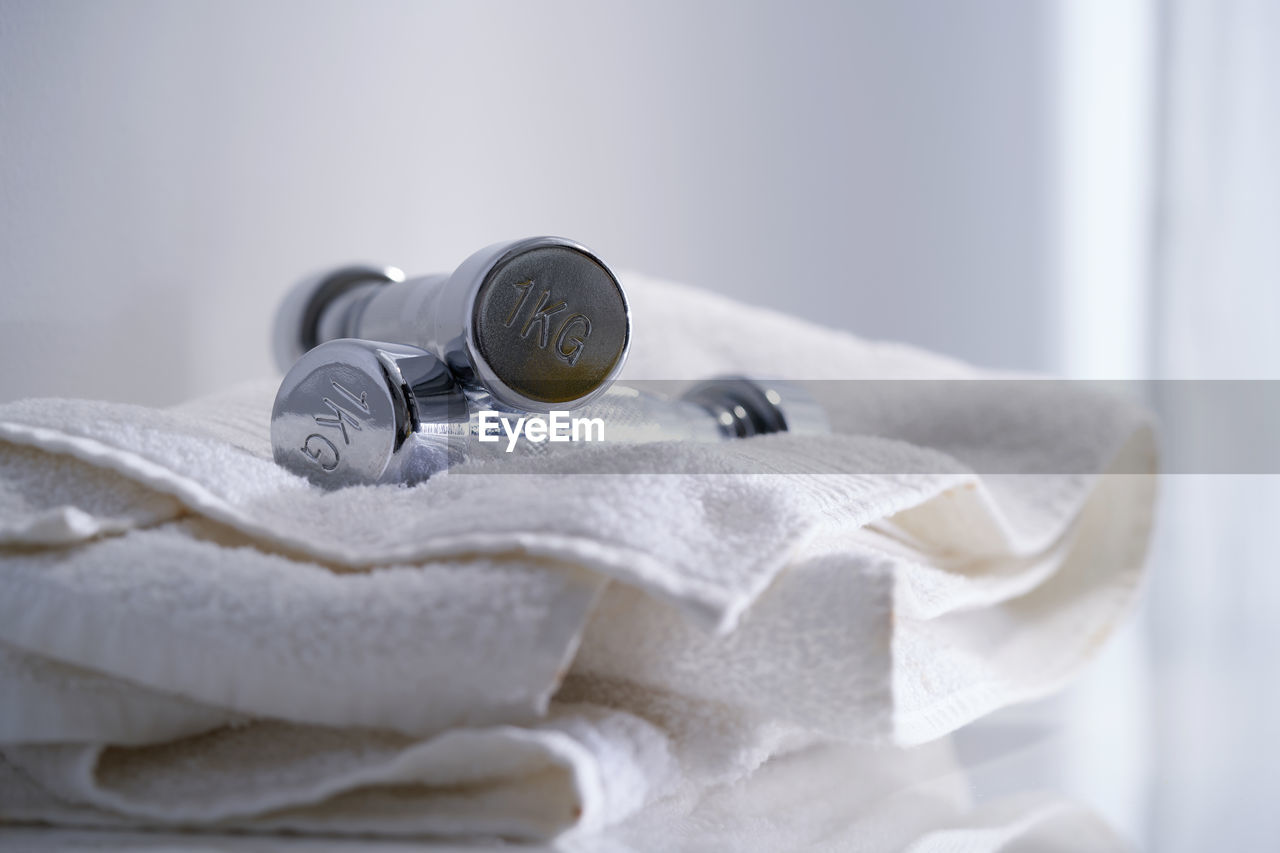 Silver dumbbell and white towel - healthy lifestyle concept