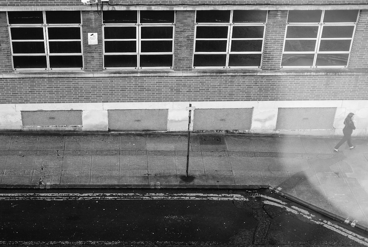 HIGH ANGLE VIEW OF PEOPLE WALKING ON ROAD