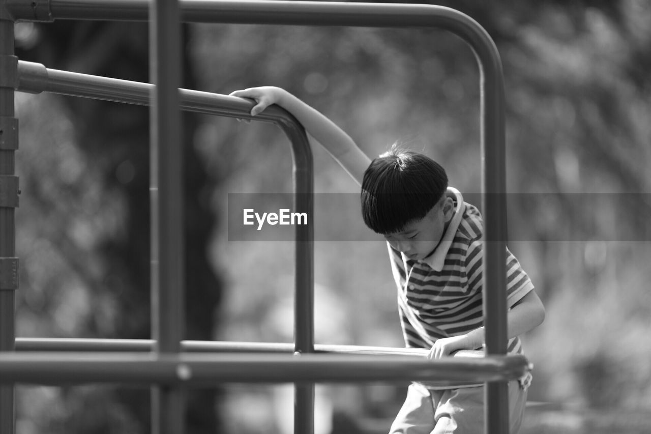 BOY PLAYING IN PLAYGROUND