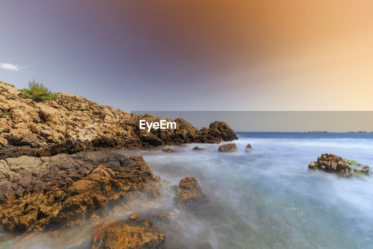 scenic view of beach against clear sky