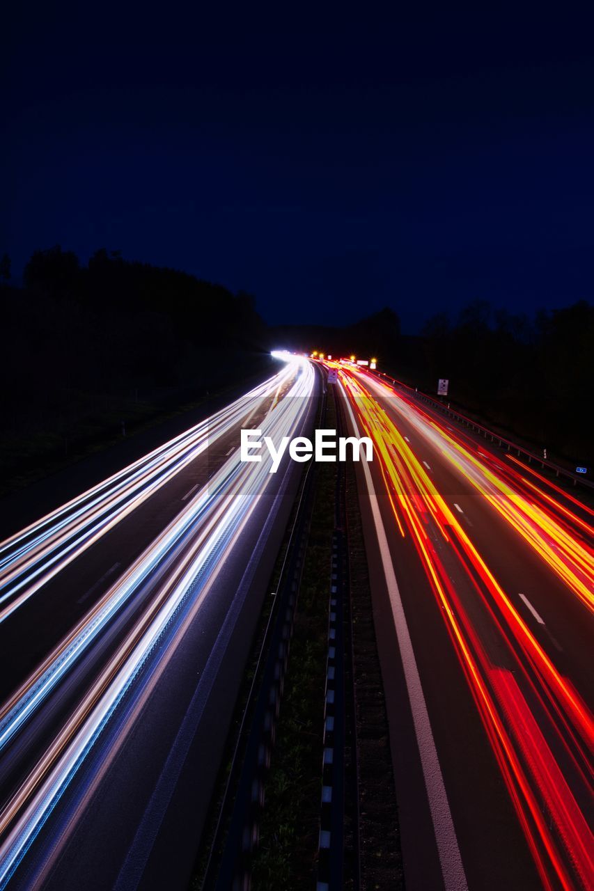 High angle view of light trails on highway at night